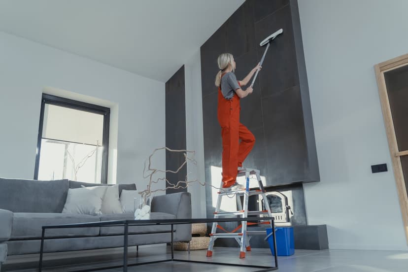 Lady cleaning the wall with a mop