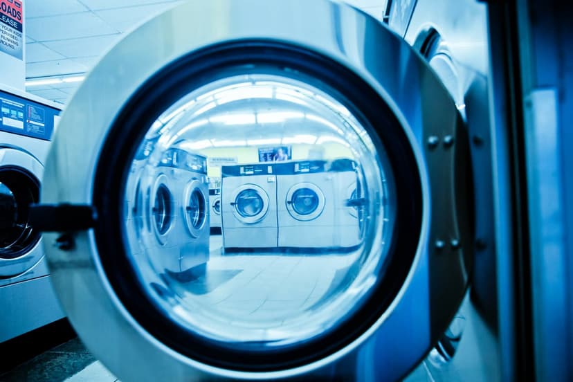 Opened washer door with other washers and dryers in the background