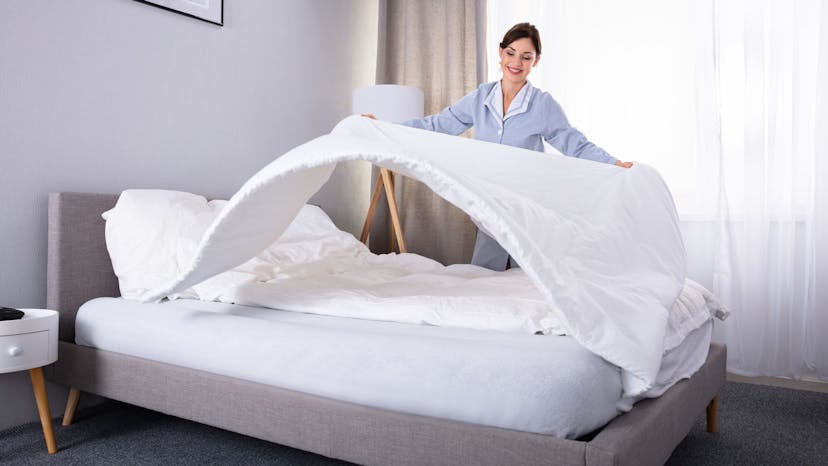 Airbnb cleaner making the bed