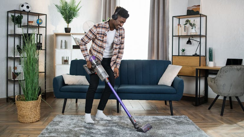 Cleaner listening to a podcast while vacuuming living room