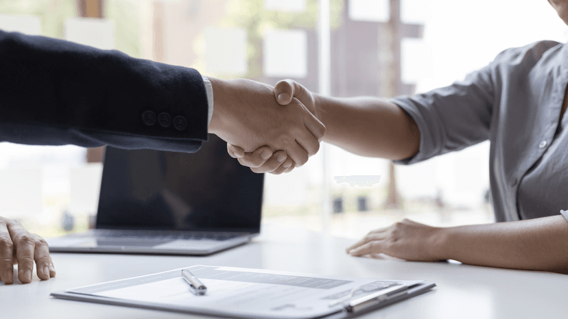 Man in suit shaking hands with a female