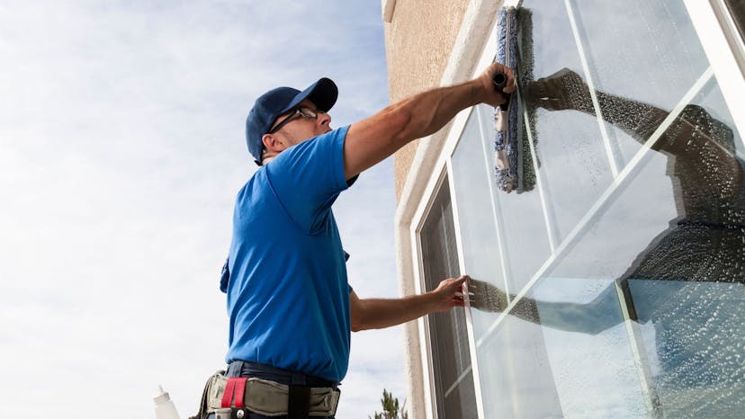 Window cleaning service man drying windows