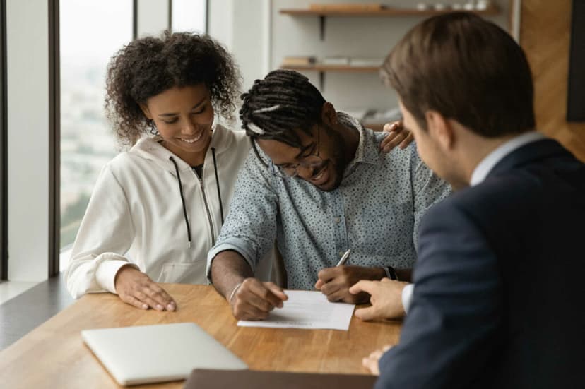 Couple signing contract at a table
