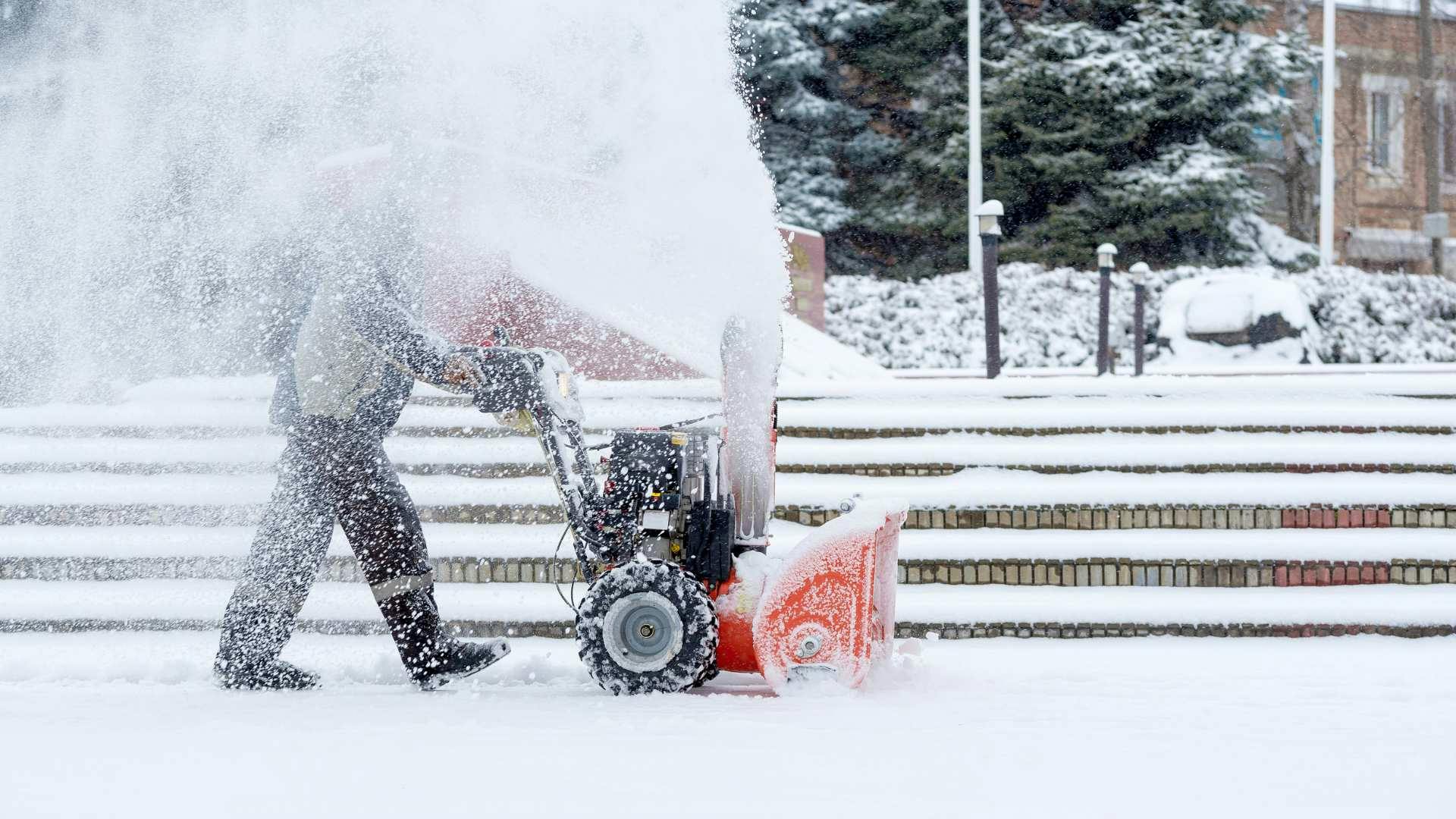 Male using a snow removal machine
